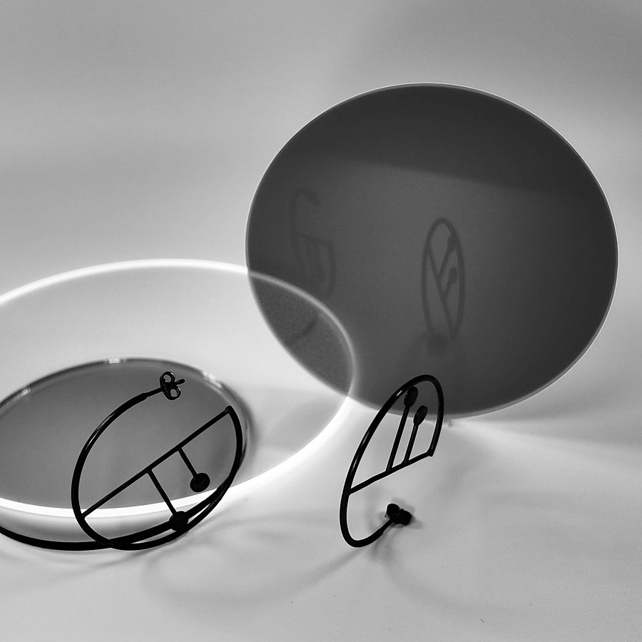 Black wire hoop earrings with a small circle and a quarter-circle line